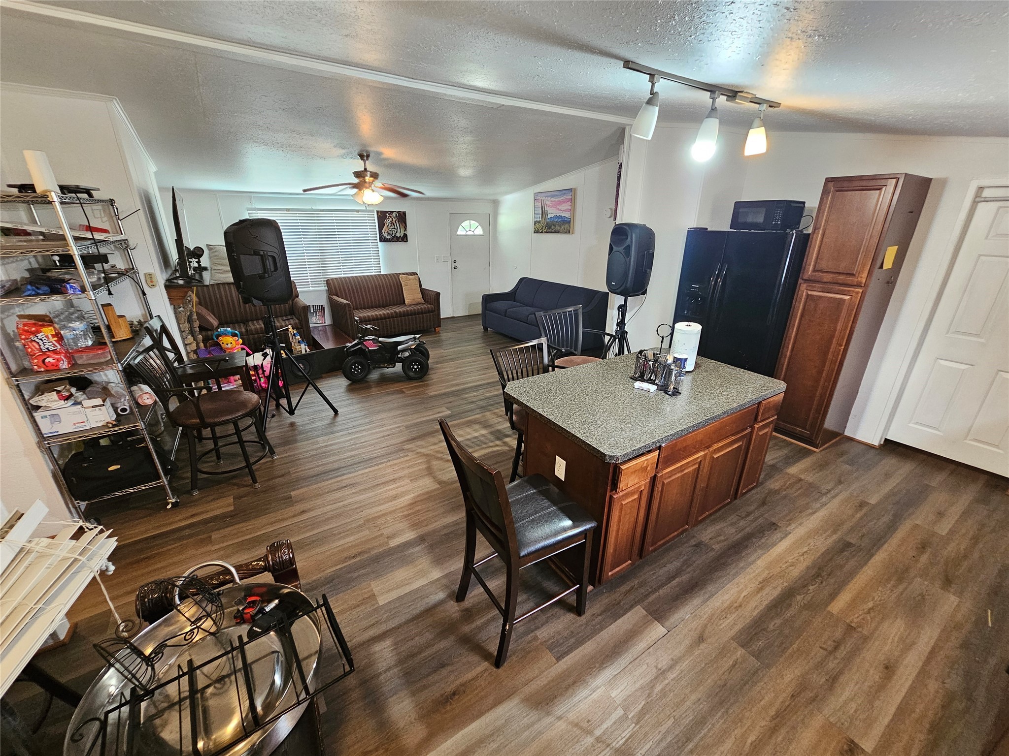 15519 Schank Road Conroe, TX 77306 - Photo 8 of 15 a living room with furniture a flat screen tv and a table