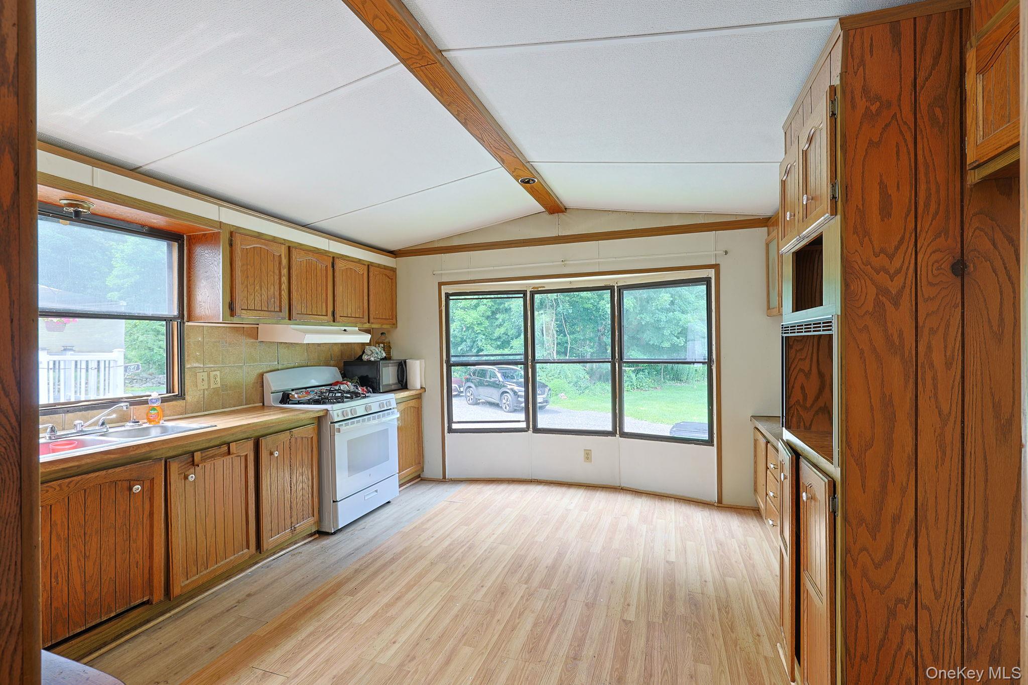63 Tanglewood Road Hopewell Junction, NY 12533 - Photo 7 of 20 a large kitchen with stainless steel appliances granite countertop a stove and a wooden floors