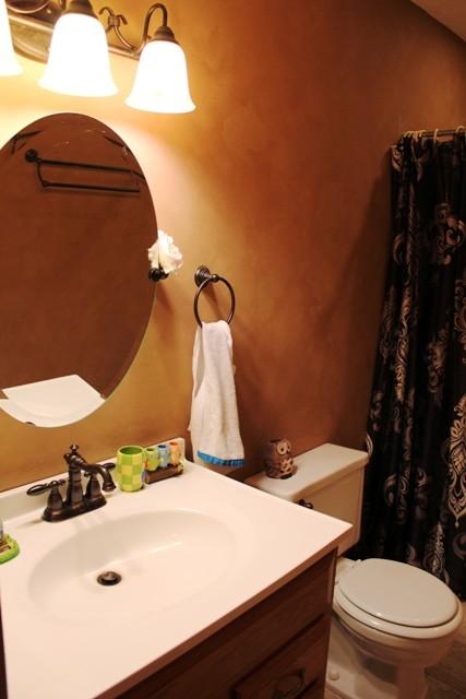 1309 Callaway Road Rocky Mount, VA 24151 - Photo 14 of 25 a bathroom with a sink and mirror with toilet