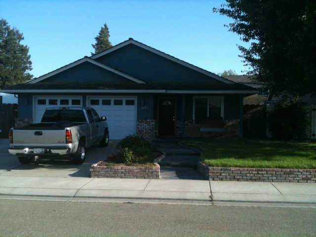 1664 Davis Street Ripon, CA 95366 - Photo 1 of 8 a front view of a house with a garden