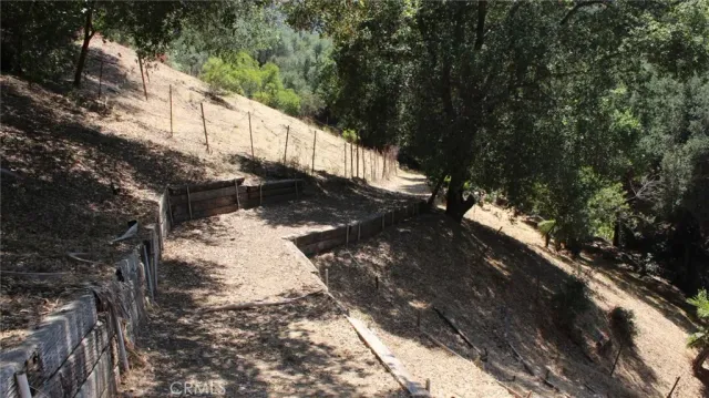 a view of a wooden fence with trees in the background