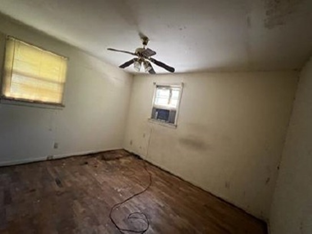1208 State Rd S-40-929 Columbia, SC 29210 - Photo 7 of 12 Original hardwood flooring and a ceiling fan create a comfortable setting in this generously sized bedroom.