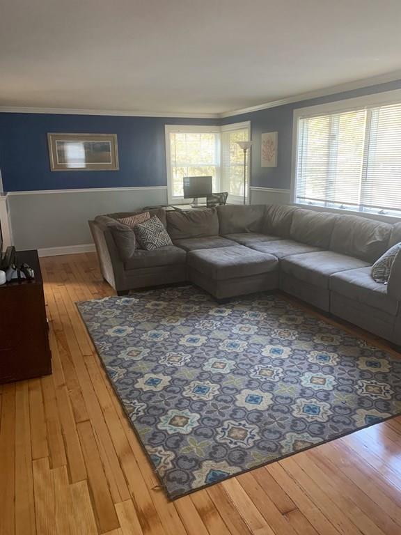 239 Windemere Street Springfield, MA 01104 - Photo 15 of 32 a living room with a couch wooden floor and a large window