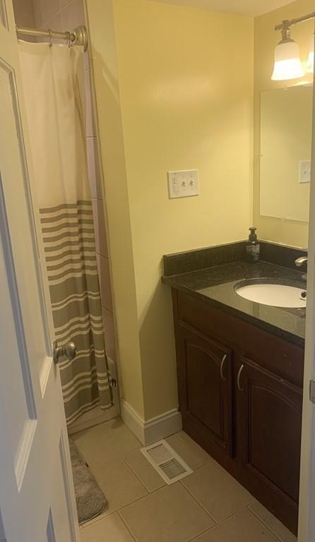 239 Windemere Street Springfield, MA 01104 - Photo 17 of 32 a bathroom with a granite countertop sink and a mirror