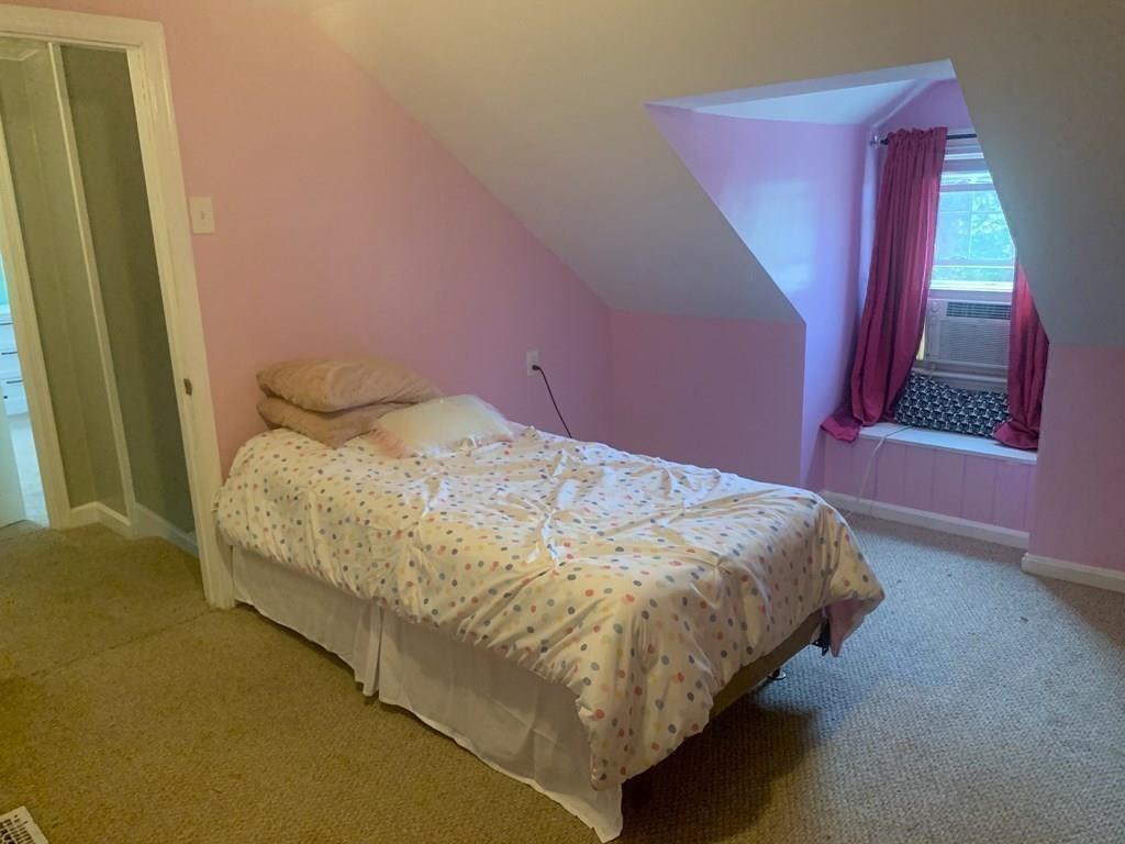 239 Windemere Street Springfield, MA 01104 - Photo 27 of 32 a bed sitting in a bedroom next to a window