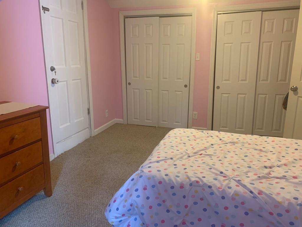 239 Windemere Street Springfield, MA 01104 - Photo 28 of 32 a bedroom with a bed and a dresser