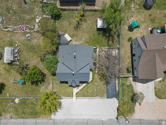 137 West 200 S Street Fairview, UT 84629 - Photo 27 of 34 Residential property featuring a dark grey shingle roof, a light-colored sidewalk leading to the entrance, and mature trees on the perimeter