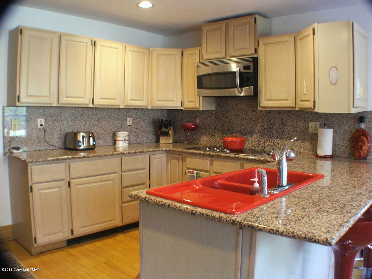 488 Rinker Road Stroudsburg, PA 18360 - Photo 15 of 54 a kitchen with stainless steel appliances granite countertop a sink dishwasher stove and cabinets with wooden floor