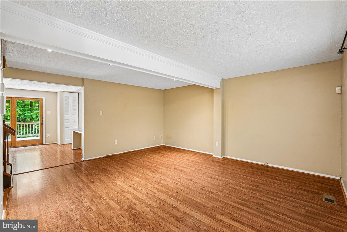 2331 Middle Creek Lane Reston, VA 20191 - Photo 11 of 78 a view of an empty room with wooden floor and a window