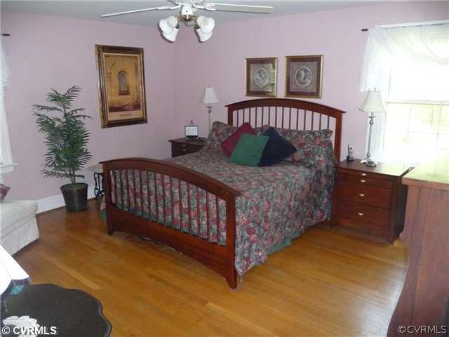 4407 Wakefield Road Richmond, VA 23225 - Photo 7 of 11 a bed sitting in a bedroom next to a window
