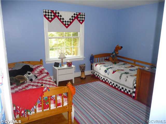 4407 Wakefield Road Richmond, VA 23225 - Photo 8 of 11 a bed sitting in a bedroom next to a window