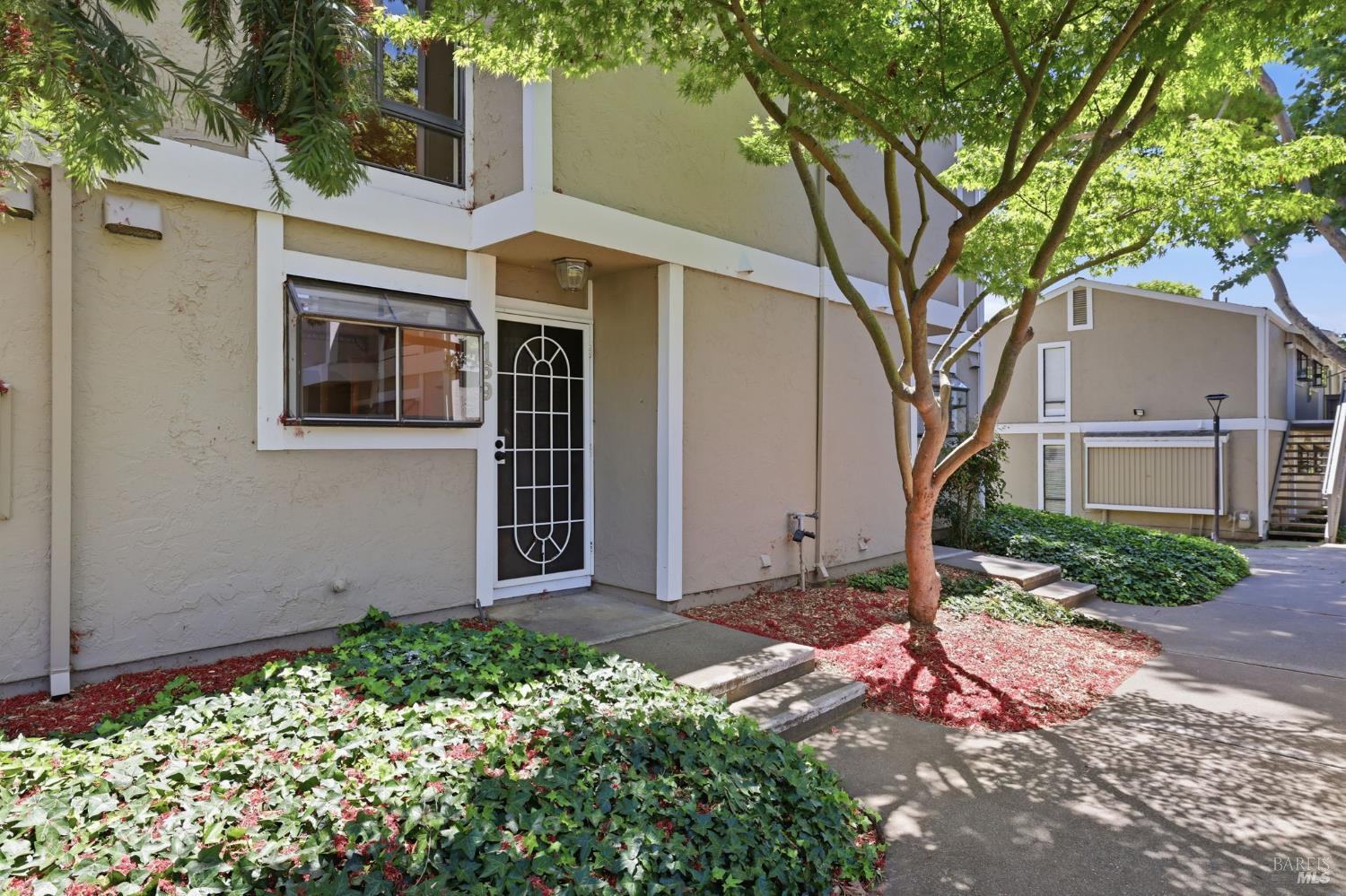 900 Southampton Road, Unit 169 Benicia, CA 94510 - Photo 3 of 21 front view of a house with a tree