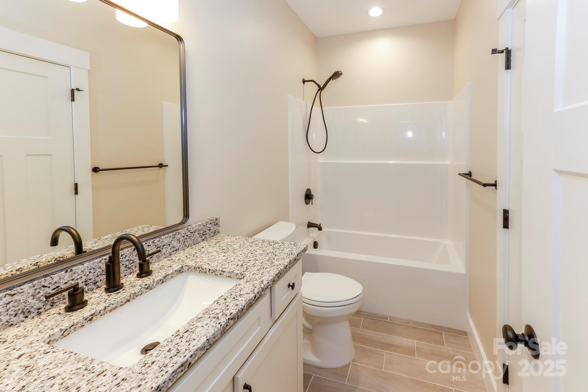 160 Northridge Drive Rutherfordton, NC 28139 - Photo 18 of 37 a bathroom with a granite countertop sink a toilet and shower