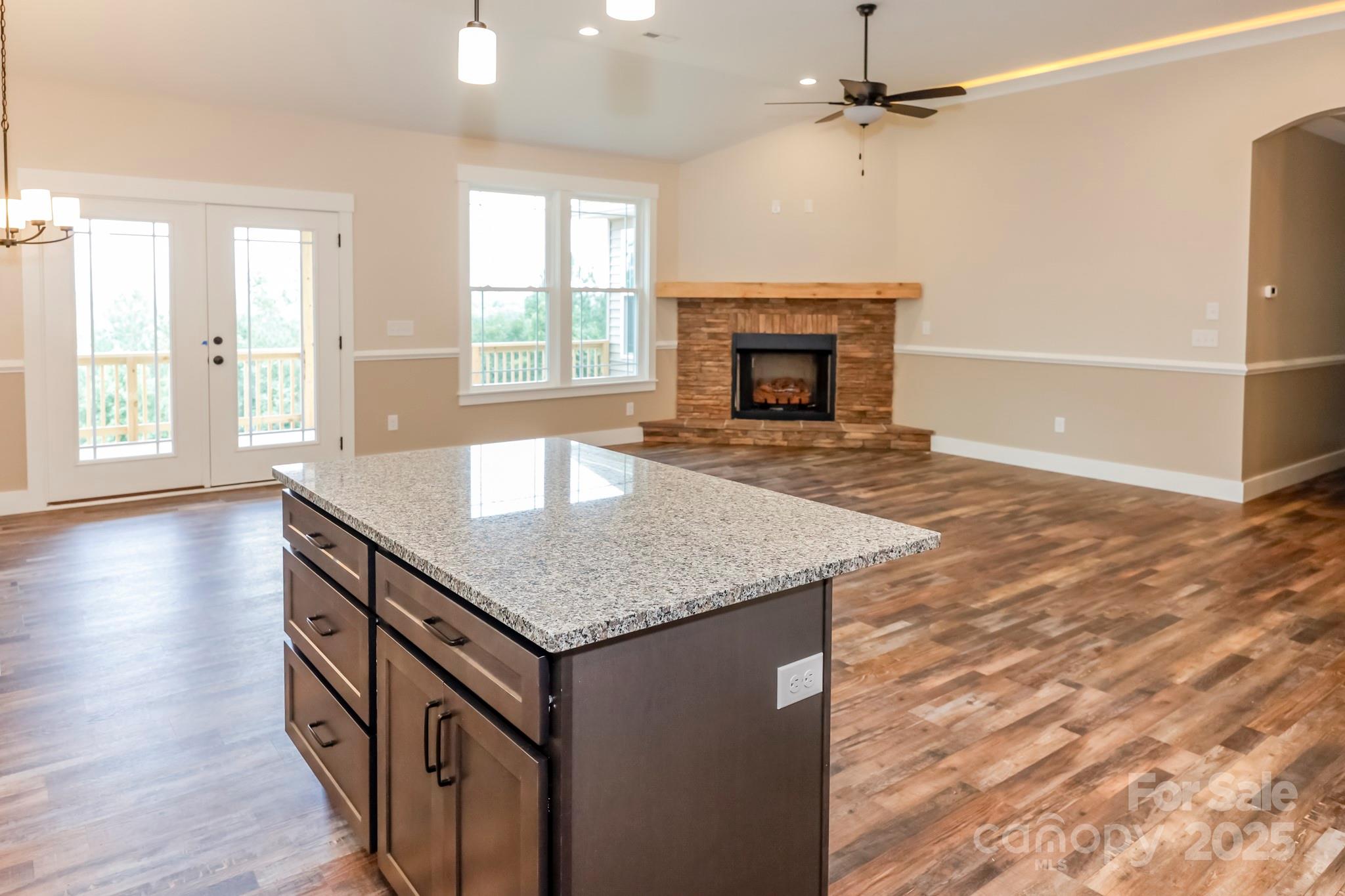 160 Northridge Drive Rutherfordton, NC 28139 - Photo 3 of 37 an empty room with wooden floor and fireplace