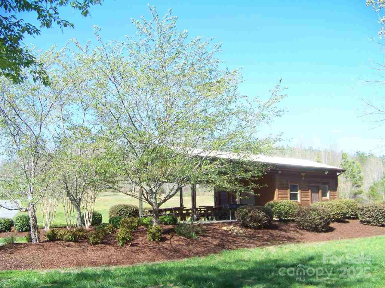 160 Northridge Drive Rutherfordton, NC 28139 - Photo 34 of 37 a view of a yard in front of a house with plants and large trees