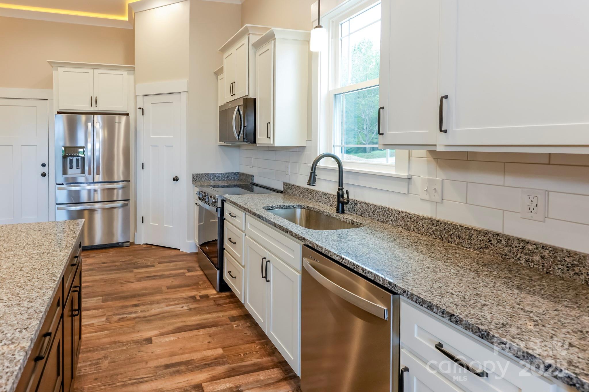 160 Northridge Drive Rutherfordton, NC 28139 - Photo 5 of 37 a kitchen with stainless steel appliances granite countertop a sink stove and refrigerator