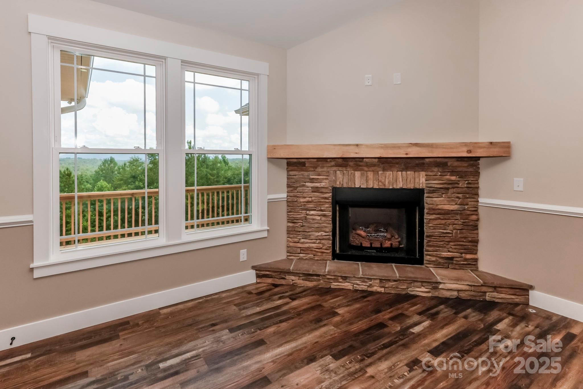 160 Northridge Drive Rutherfordton, NC 28139 - Photo 8 of 37 a view of an empty room with wooden floor fireplace and a window