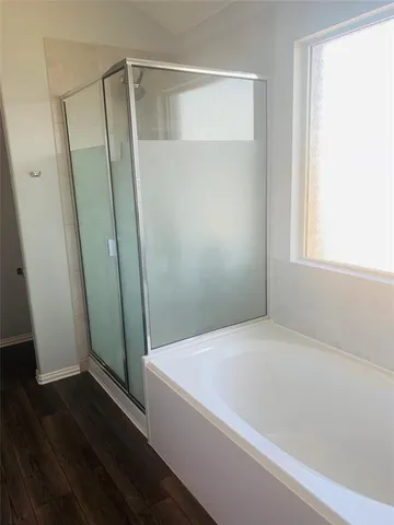 a bathroom with a bathtub and a shower