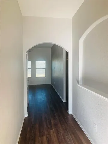 a view of wooden floor and windows in a room
