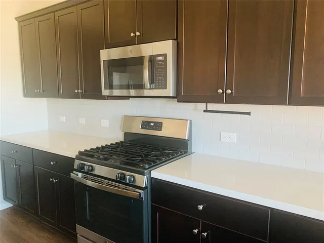 a kitchen with a stove and a microwave