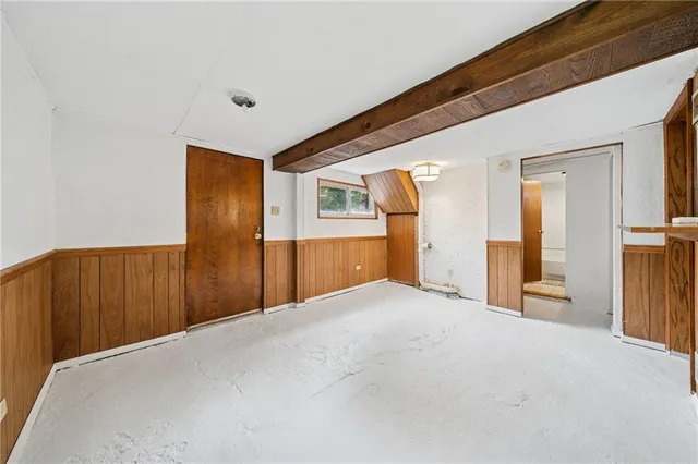 a view of empty room with a kitchen