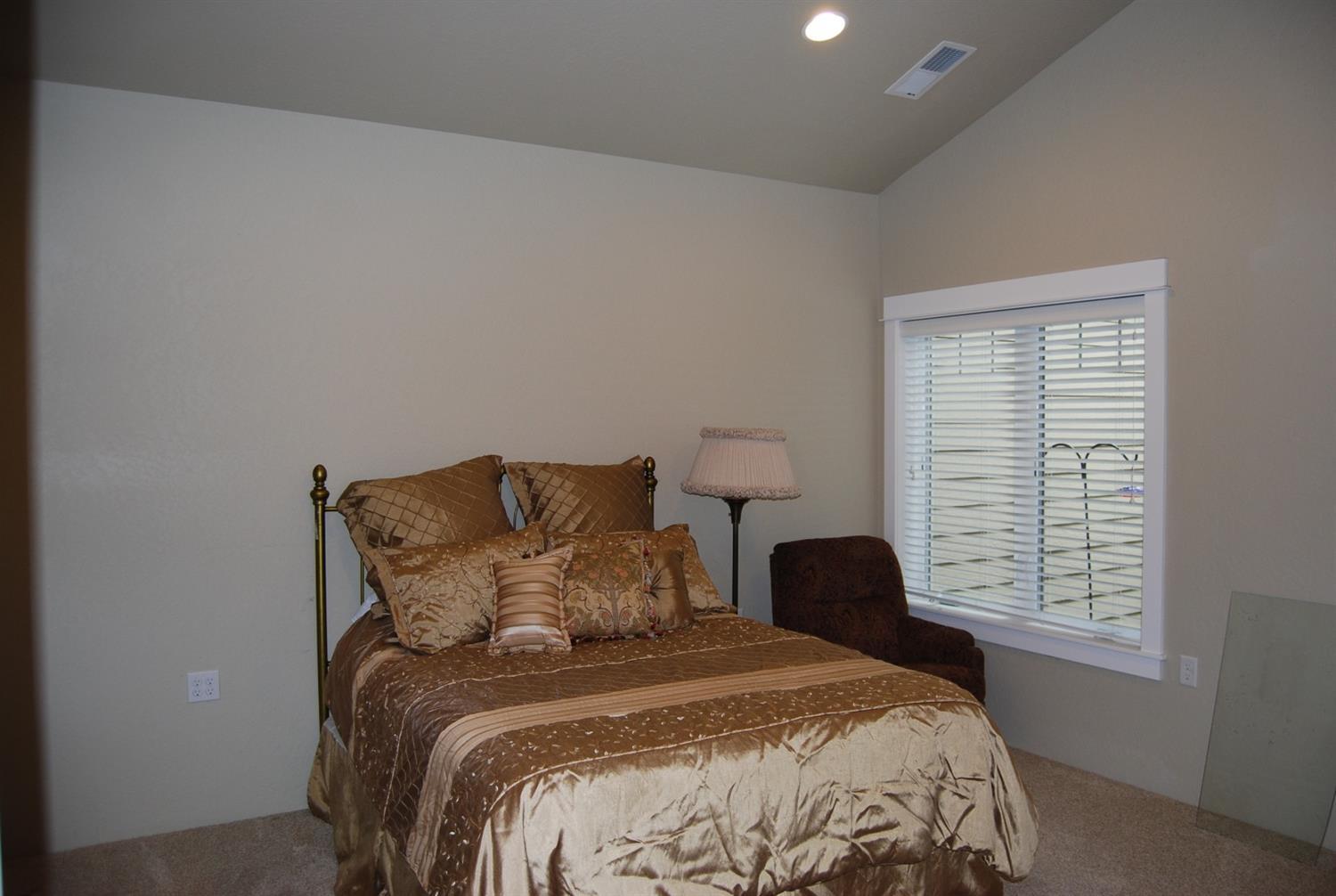 1171 North Haskell Street Central Point, OR 97502 - Photo 12 of 19 a large bed sitting in a bedroom next to a window
