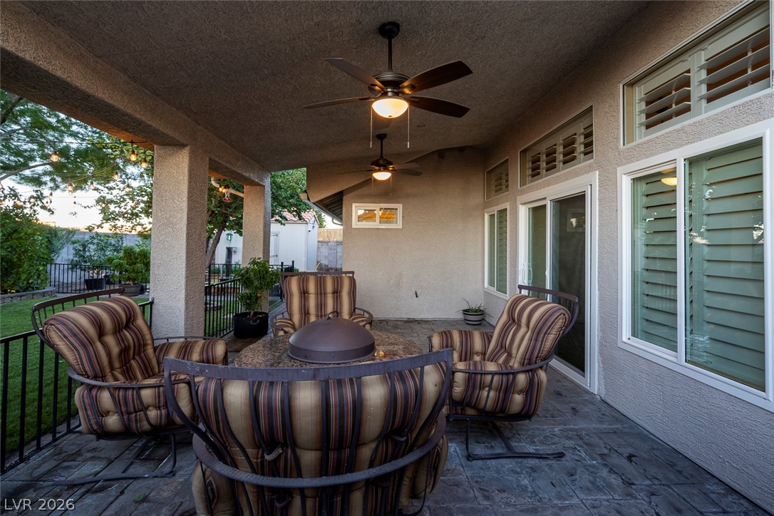 818 Manor Shores Road Henderson, NV 89002 - Photo 6 of 35 Enjoy evening breezes and serene garden views from this covered patio, perfect for relaxation and gathering.