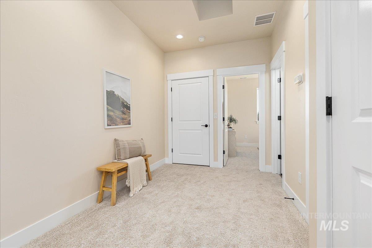 1439 North Bluffs Ridge Lane Boise, ID 83704 - Photo 31 of 47 Corridor featuring light colored carpet and baseboards