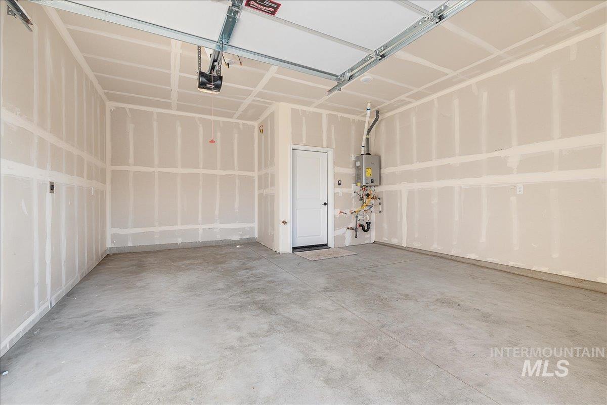 1439 North Bluffs Ridge Lane Boise, ID 83704 - Photo 10 of 47 Garage featuring a garage door opener and water heater