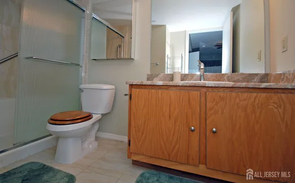 a bathroom with a toilet a sink and mirror