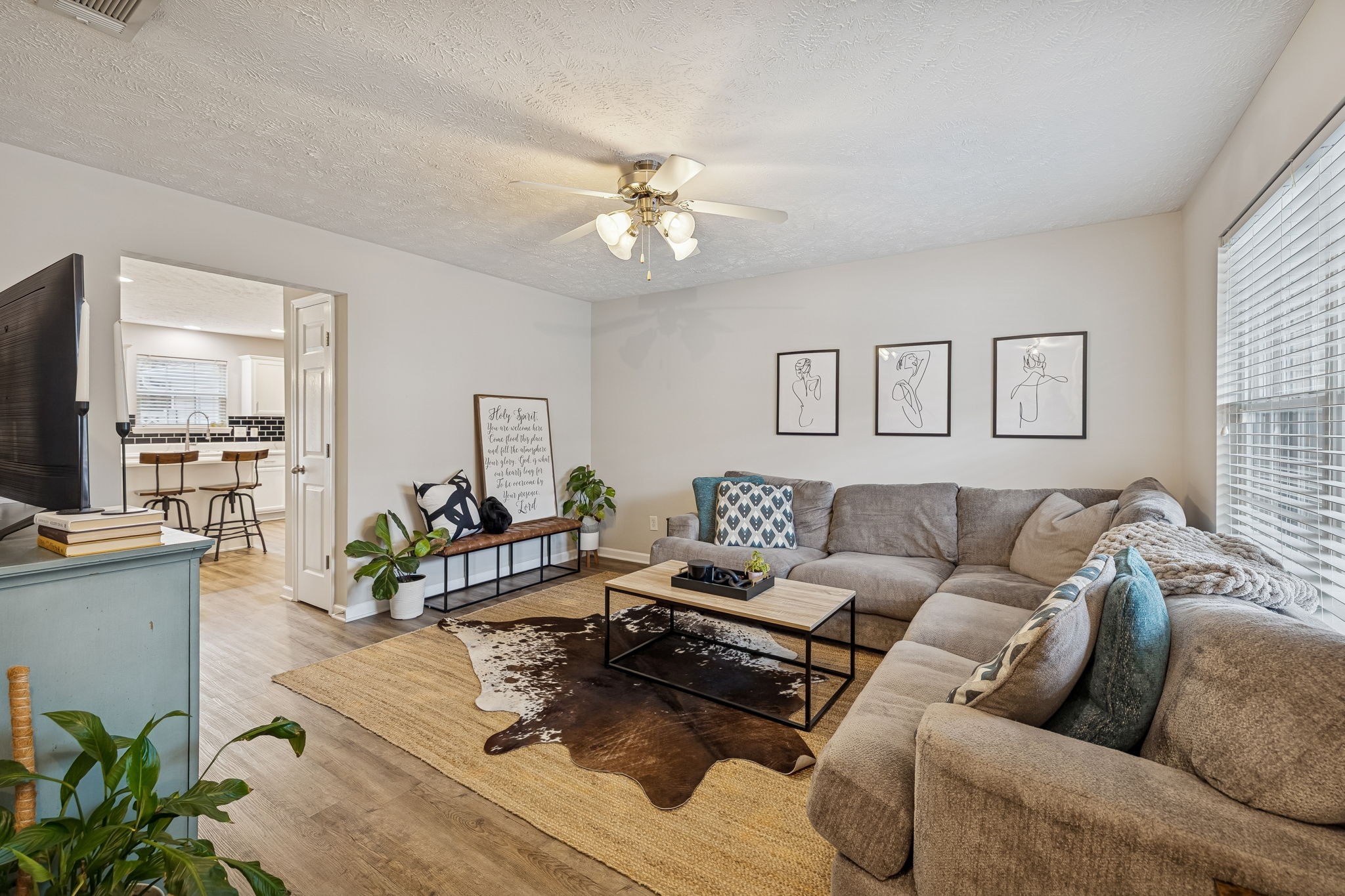 a living room with furniture and a wooden floor