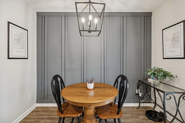 a view of a dining room with furniture and chandelier