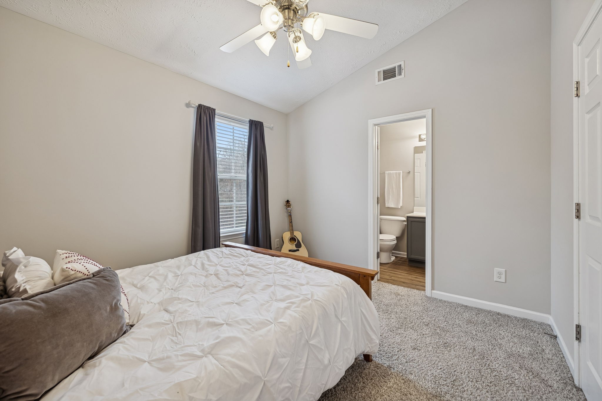 1834 Shaylin Loop Antioch, TN 37013 - Photo 21 of 28 a bedroom with a bed and a chandelier