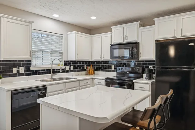 a kitchen with a white stove top oven and refrigerator