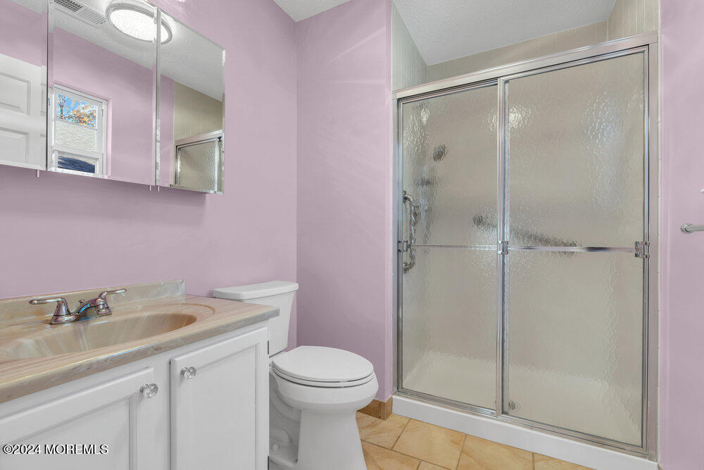 18 Mayapple Drive Brick, NJ 08724 - Photo 26 of 41 a bathroom with a shower sink vanity granite and toilet
