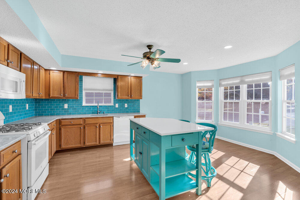 18 Mayapple Drive Brick, NJ 08724 - Photo 9 of 41 a kitchen with stainless steel appliances granite countertop a stove a sink dishwasher and a refrigerator with wooden floor