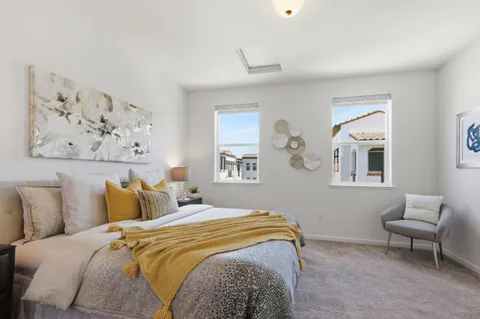 a bedroom with a bed and a painting on the wall