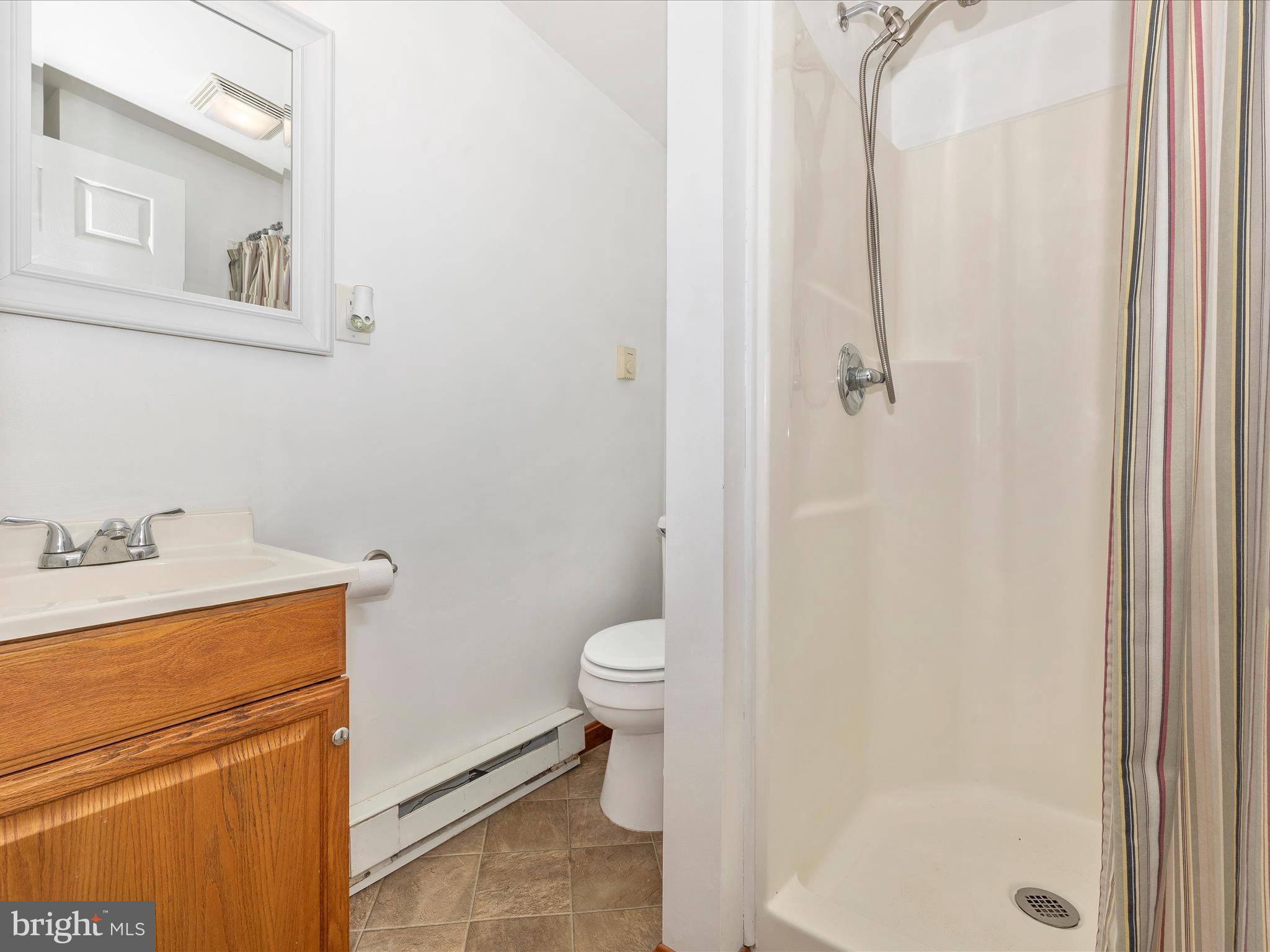 5905 Clevelandtown Road Boonsboro, MD 21713 - Photo 28 of 54 a bathroom with a granite countertop toilet a sink and a mirror