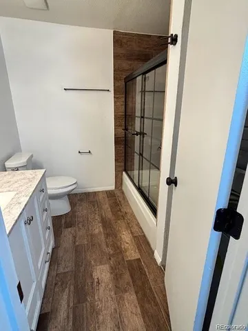 a bathroom with a glass shower door