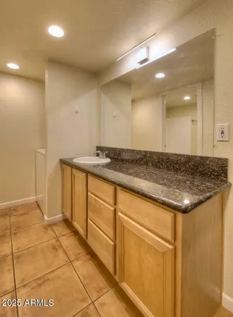a view of a refrigerator a sink and cabinets