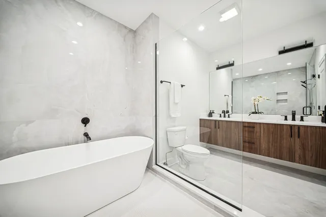 a bathroom with a bathtub and a shower