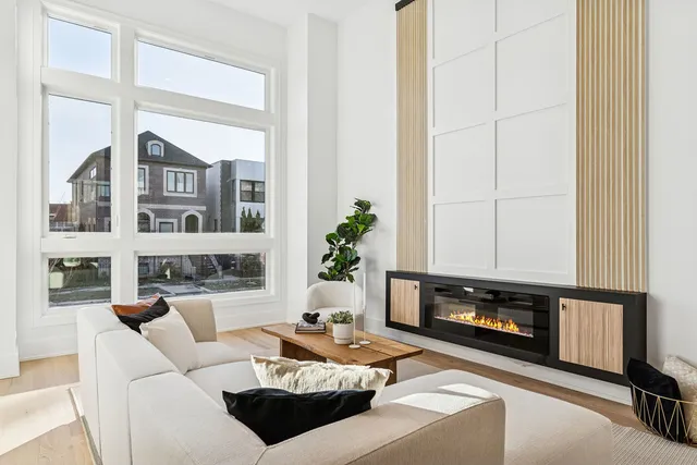 a living room with furniture a fireplace and a window