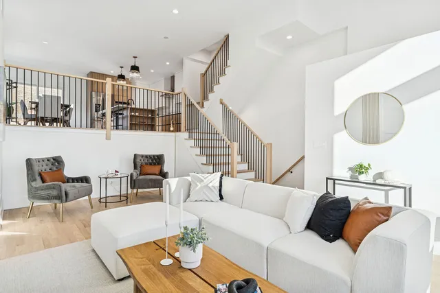 a living room with furniture and a painting