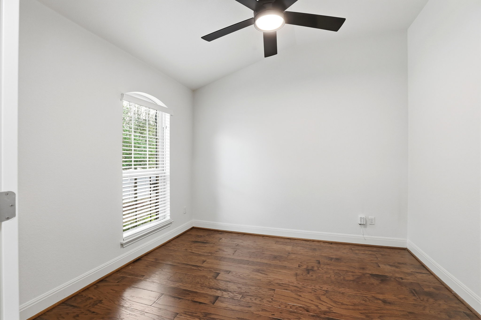 152 Stone View Trail Austin, TX 78737 - Photo 7 of 33 Spare room with vaulted ceiling, dark wood finished floors, and ceiling fan