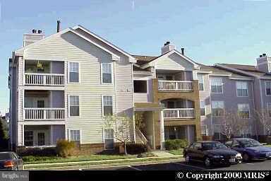 21019 Timber Ridge Terrace, Unit 201 Ashburn, VA 20147 - Photo 1 of 1 a front view of a house with a yard
