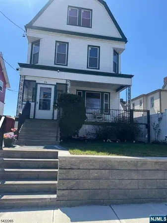 a view of a house with a small yard and a large window