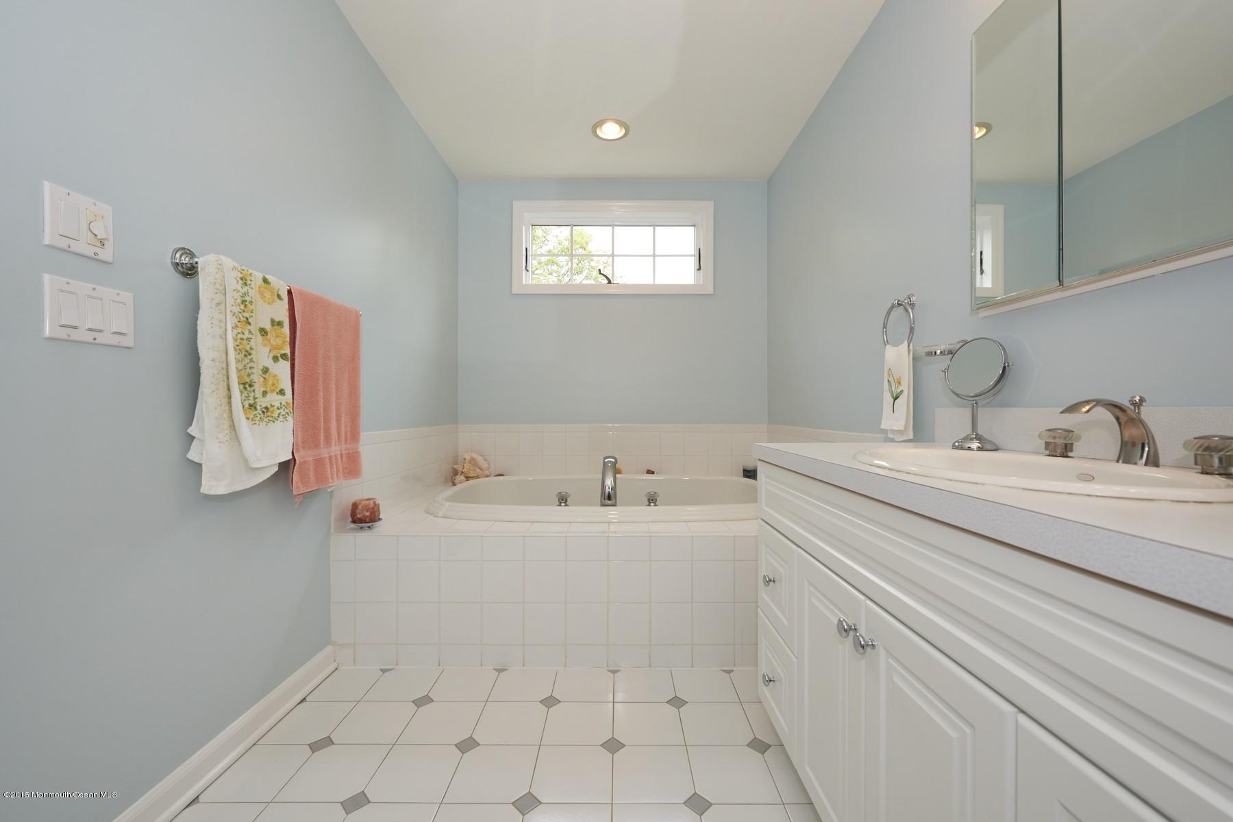 150 Bowne Road Middletown, NJ 07716 - Photo 12 of 20 a bathroom with a sink a toilet and mirror