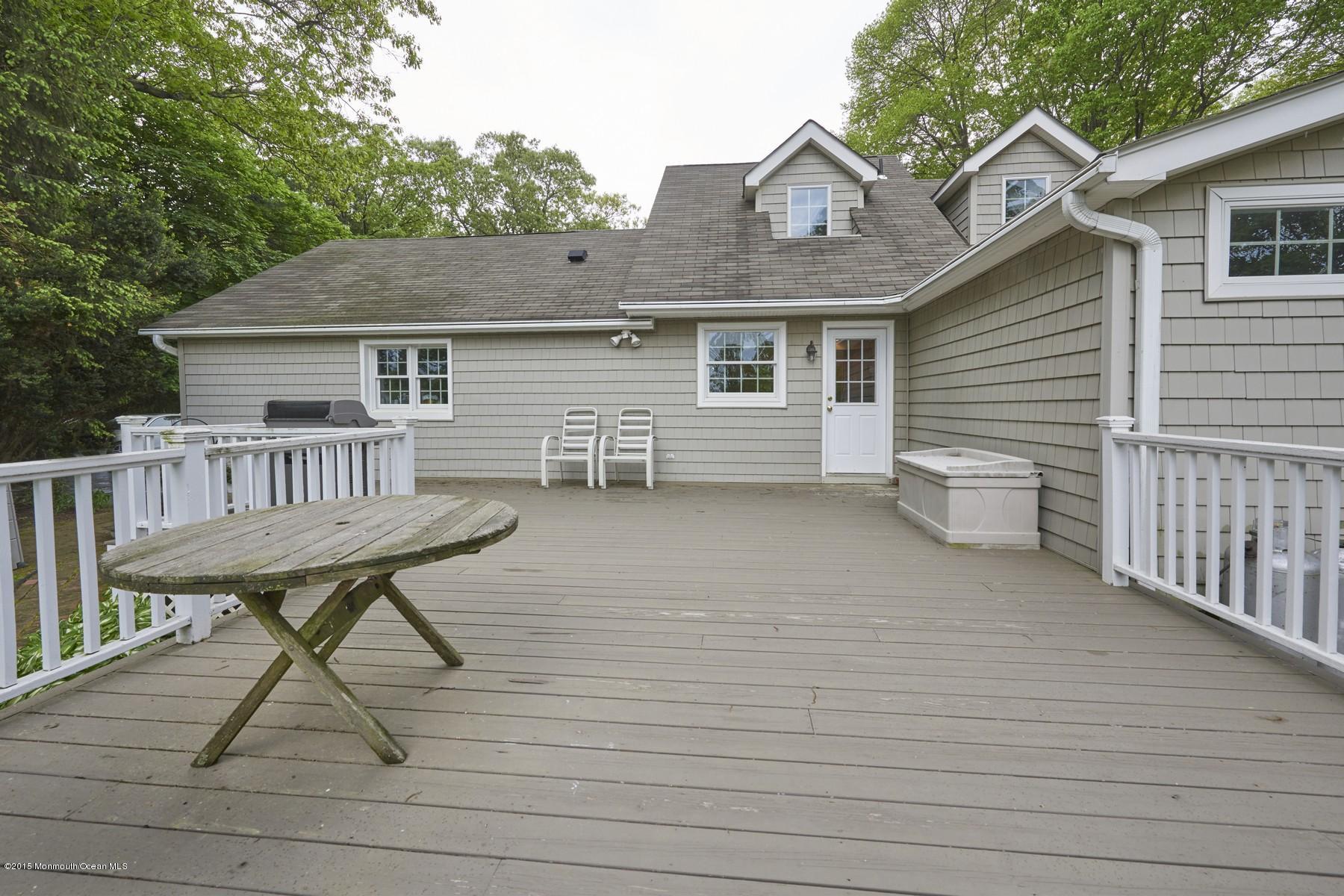150 Bowne Road Middletown, NJ 07716 - Photo 17 of 20 a view of a house with a wooden deck and a yard