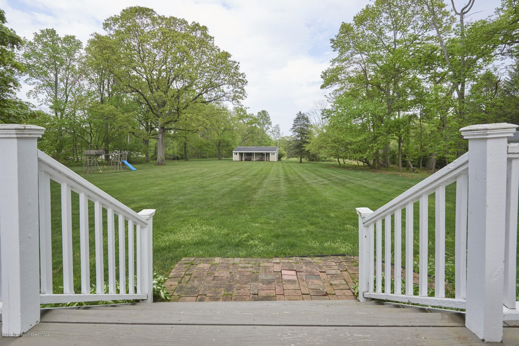 150 Bowne Road Middletown, NJ 07716 - Photo 18 of 20 a view of a deck with a yard and wooden fence