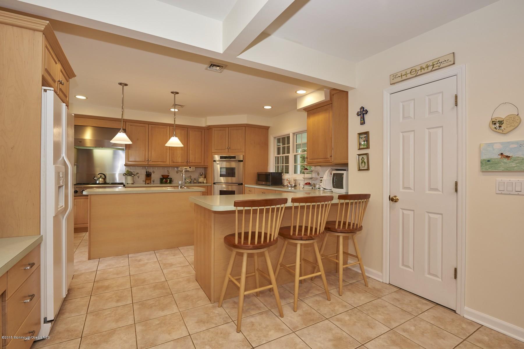 150 Bowne Road Middletown, NJ 07716 - Photo 3 of 20 a dining hall with stainless steel appliances a dining table and chairs